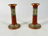 pair of orange vases with blue and gold designs on them