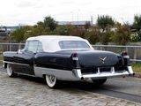 a black and white car that is parked on the side of the road