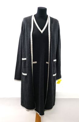black coat with white trims on a mannequin mannequin mannequin mannequin mannequin mannequin mannequin mannequin