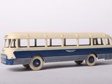 a toy bus that is sitting on a white surface