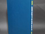 a blue book sitting on top of a gray surface