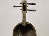 a sculpture of a violin on display in a museum