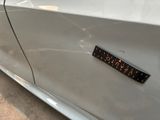 a close up of a car door with a sticker on it