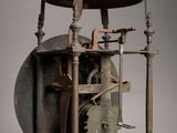 a clock that is sitting on a stand with a light on top