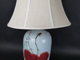 a lamp that is sitting on a table with a lamp shade on it