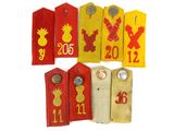 five wooden tags with different designs and numbers on them