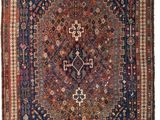 an antique persian rug with a geometric design and fringe fringes