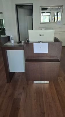 a small desk with a laptop on it in the middle of a room