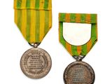two medals and a medal with a ribbon on a white background