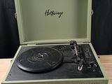a record player sitting on top of a wooden table