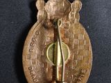 an image of a gold medal with a knife on it