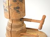 an old wooden clamp with a hammer on it
