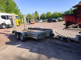 a trailer with a trailer attached to it in a parking lot