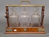 three glass decanters in a wooden case