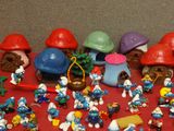 many smurfs figurines on a red table
