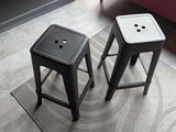 two stools sitting on a rug in a living room