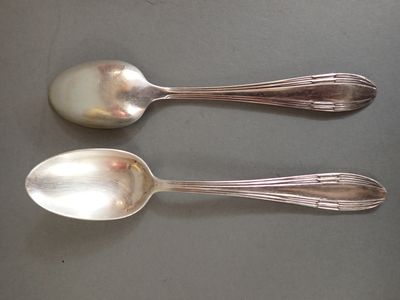 two spoons sitting next to each other on a table