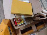 a pile of cardboard boxes and other items on the floor