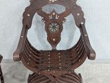 a wooden chair that has a clock on the back of it