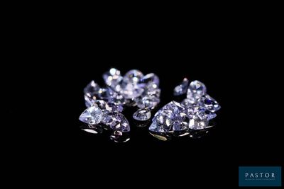 a close up of a pair of diamonds on a black background