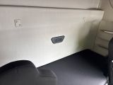 a seat in the back of a car with a remote control