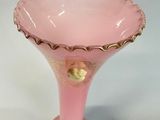 a pink glass vase with a gold decoration on it