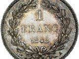 a coin with a wreath on the front of it