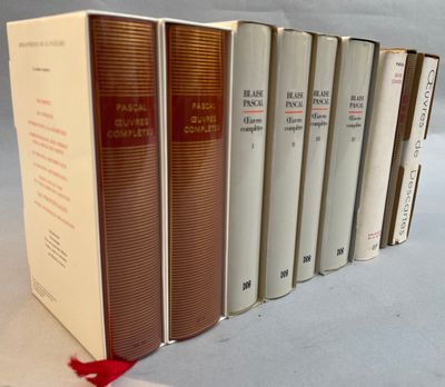 several books are lined up in a row on a white surface