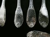 five spoons that are sitting next to each other