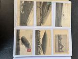 a stack of old postcards sitting on top of a table