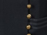 a close up of a black jacket with gold buttons