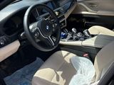 the interior of a car with the door open and the driver ' s seat down