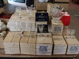 many boxes of wine glasses sitting on a table