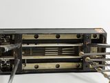 a black and gold radio that is on a white table