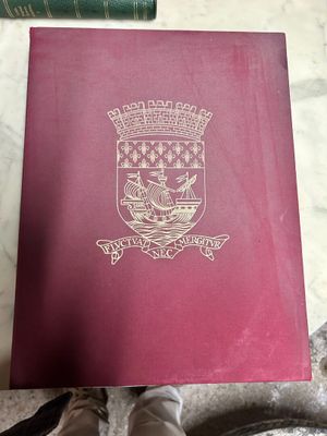 a passport sitting on a table next to a pair of shoes