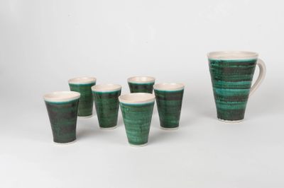 a set of six green and white cups and a pitcher