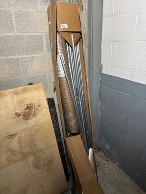 a pile of baseball bats sitting in the corner of a room
