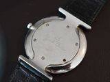 a close up of a watch on a black surface