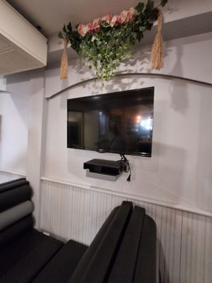 une télévision fixée au mur au-dessus d'un canapé