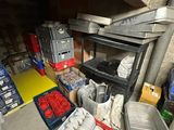 many containers of food sitting on a shelf in a room