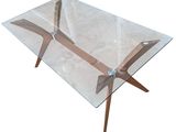 an image of a glass table with wooden legs and a glass top