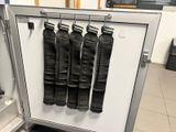 five pairs of black leather pants hanging on a rack