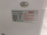 a white refrigerator with a warning sign on it