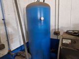 a blue water heater sitting next to a metal tank