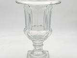 a clear glass vase with a base on a white background