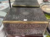 a wooden box that is sitting on top of a glass table