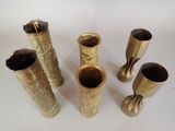 four vases that are sitting on a white surface