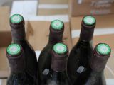 several bottles of wine are lined up on a table
