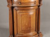 an old wooden corner cabinet with a door and a drawer