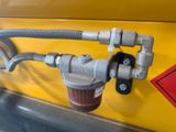 a close up of a hose attached to the side of a yellow truck